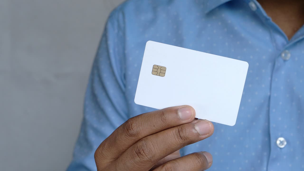 Person Holding a White Credit Card