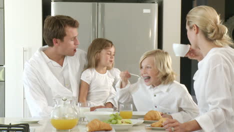 hungry family eating breakfast