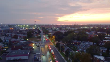 busy overhead aerial of a mid-sized town coming to live during an early morning commute in the fall