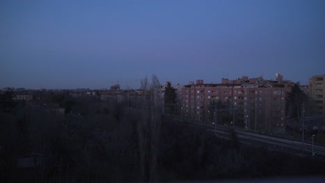 time–lapse from a window show a winter landscape at the blue hour