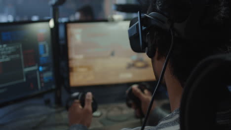 person using vr headset and controllers while gaming in a computer office setting