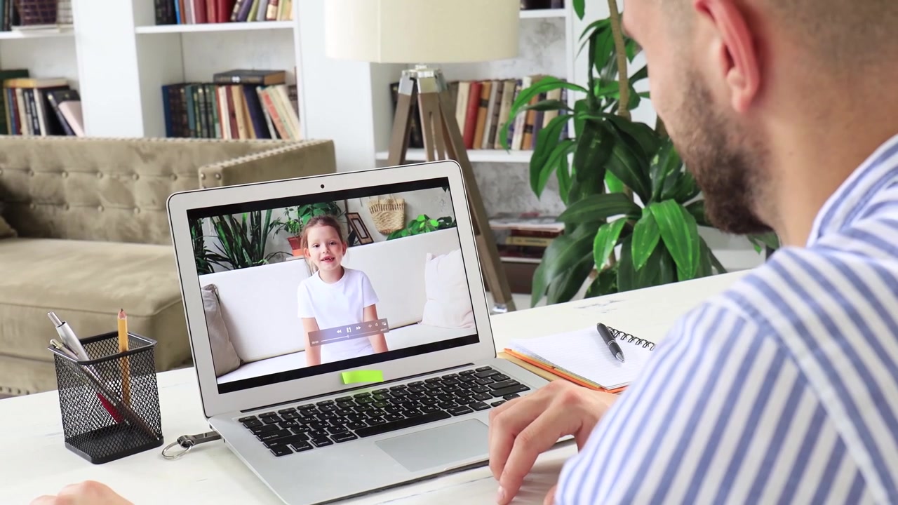 Man Having a Video Call with a Young Girl on His Laptop at Home