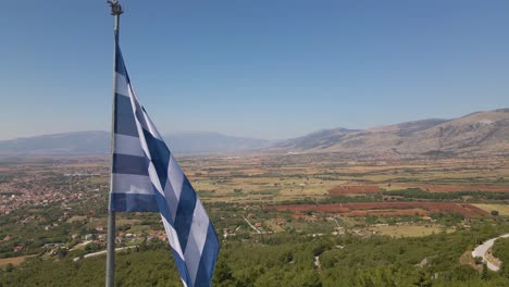 aerial drone 4k clip of a flag waving over the mount korilovos in the area of drama in northern greece