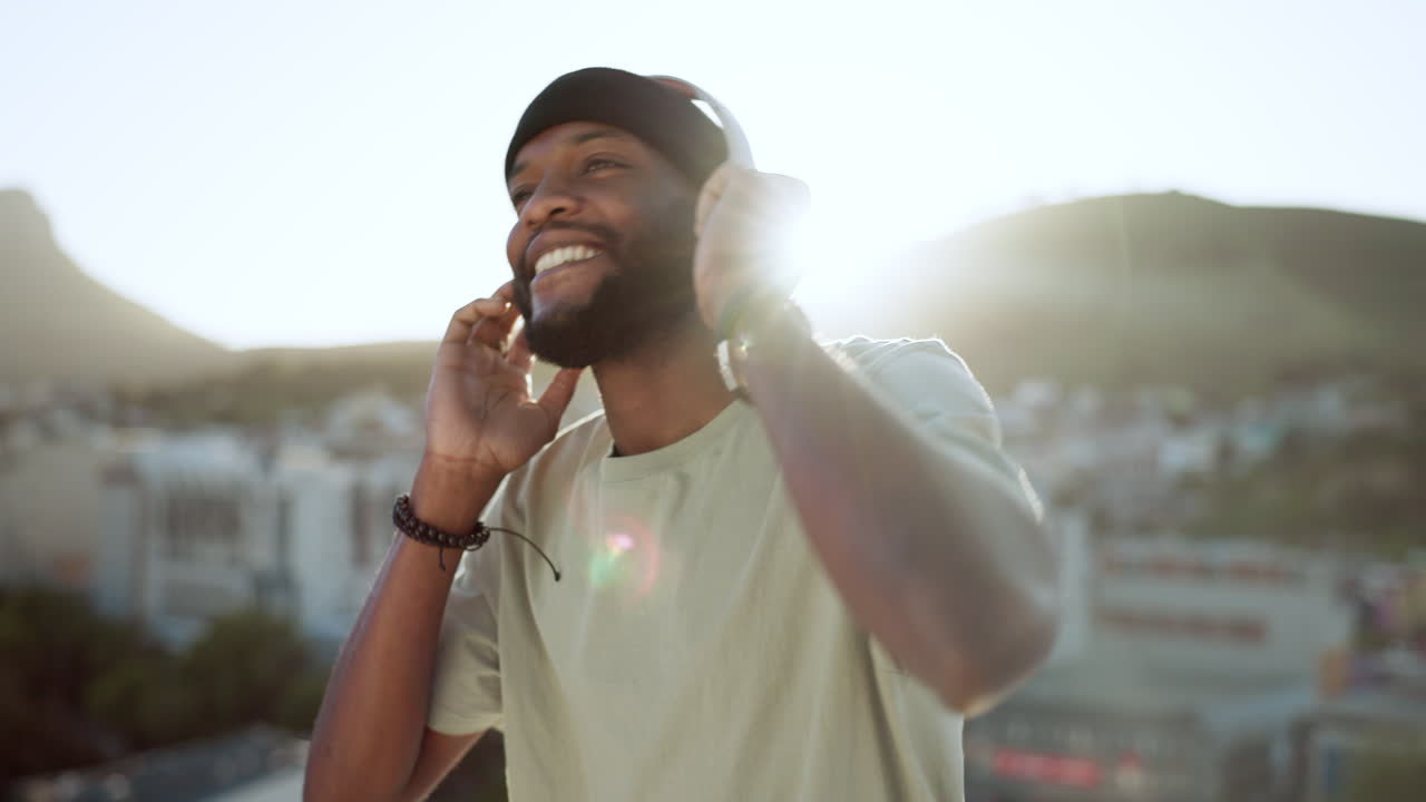 Man, music and dancing on rooftop with headphones