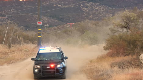 Huge-fire-with-dense-black-smoke-and-a-Sheriffs-car-with-flashing-lights