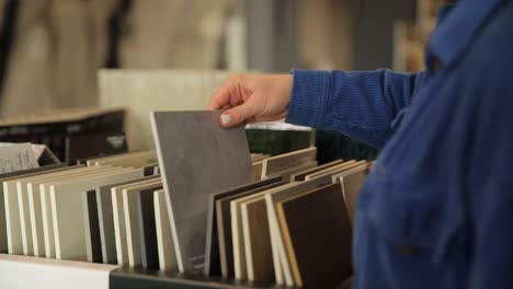 Woman Choosing Tiles in a Showroom