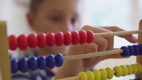 boy learning mathematics with abacus in a comfortable home 4k