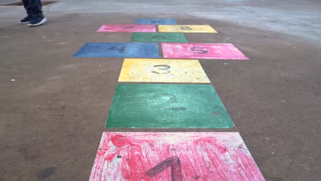 hopscotch game - numbers with colors painted on the floor