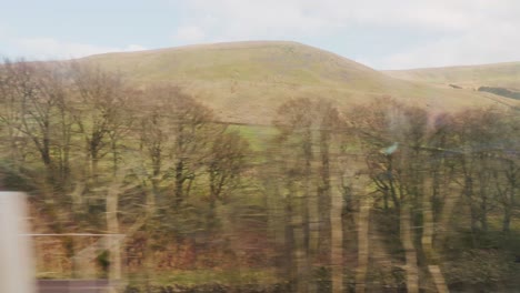 england rural countryside from inside traveling train view