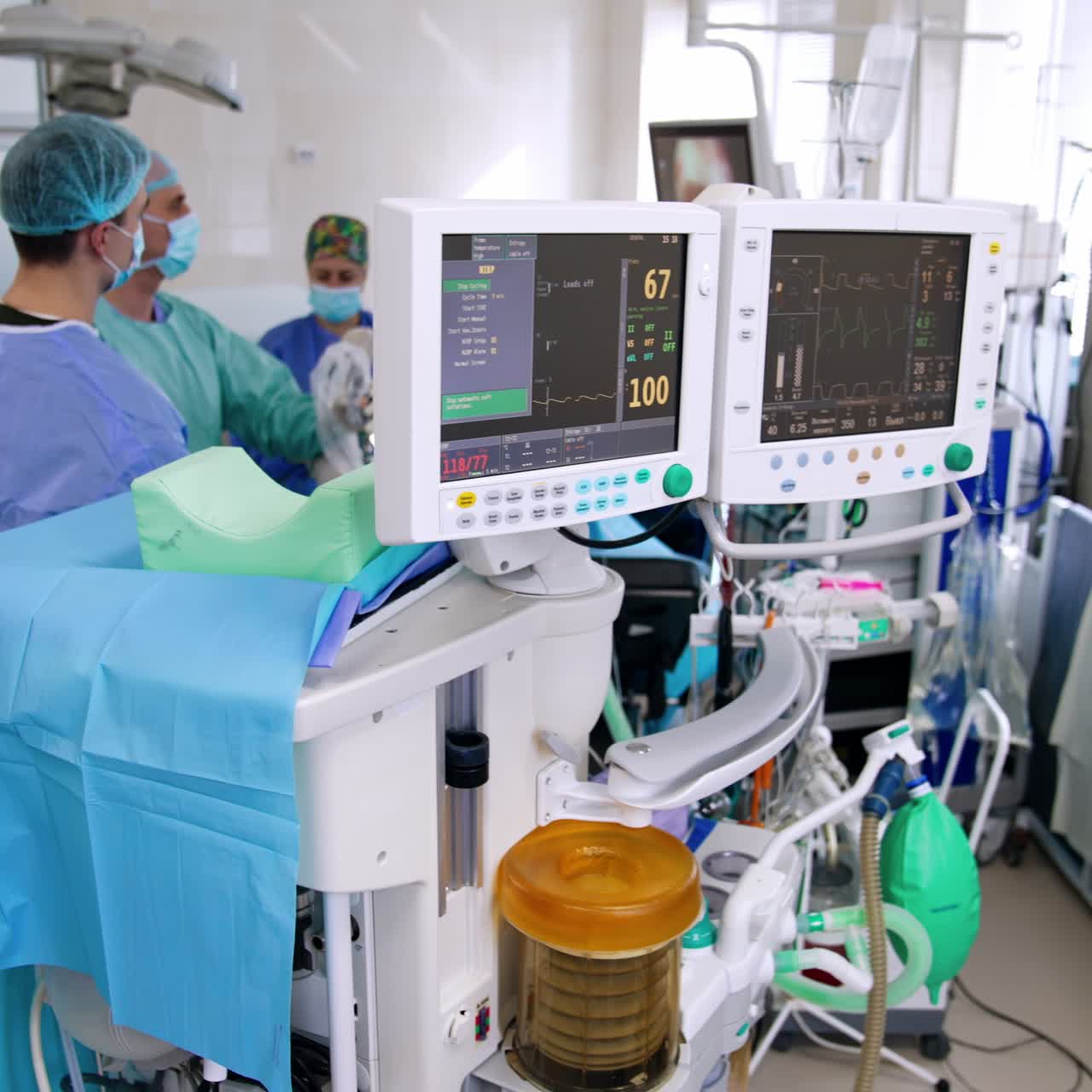 Surgeon moves laparoscopic devices input into patient's leg. Doctors look at the monitor showing the surgery from inside