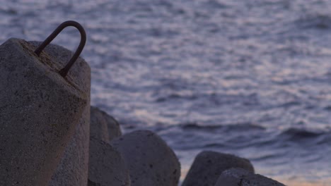 Karosta-Northern-Pier-concrete-breakwater-at-sunset-with-calm-sea-in-the-background,-medium-shot