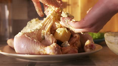 preparing a buttered herb roasted chicken