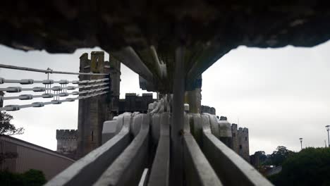 Moving-between-large-Conwy-castle-suspension-bridge-metal-engineering-steel-construction-cables-dolly-left