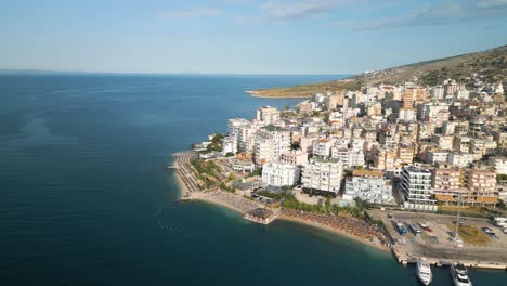 beautiful drone shot above saranda hotels and resorts with beach goers relaxing