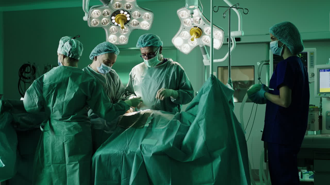 Surgical team performing operation in operating room