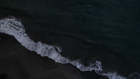 waves crashing on black sand beach, plage de grande anse bay, guadeloupe, french antilles