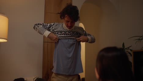 man trying on christmas sweater