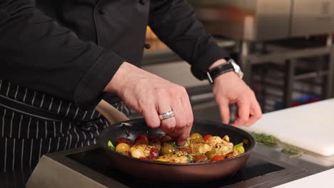 chef cooking chicken with vegetables