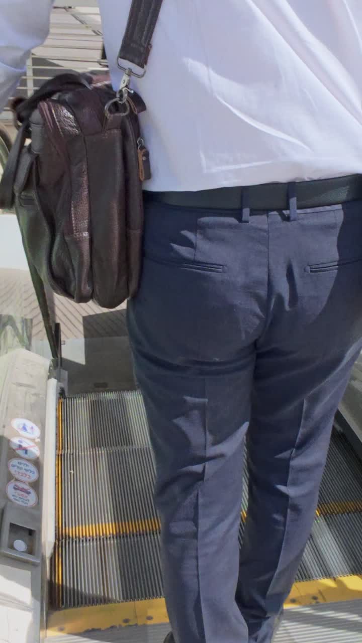 Close-up of a Businessman's Attire on an Escalator