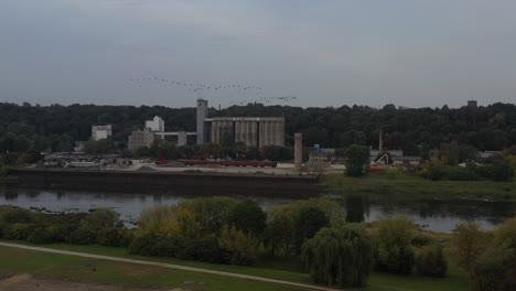 Birds-flying-over-Nemunas-river-in-Kaunas,-Lithuania