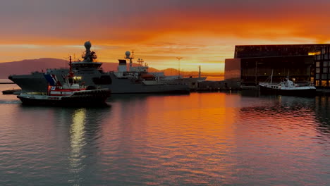 tugboat entering harbor at sunrise