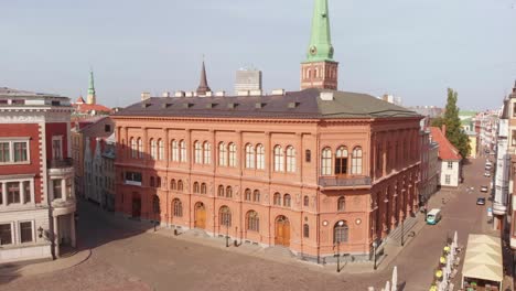 Aerial-view-of-Art-Museum-RIGA-BOURSE-on-sunny-morning-day,-backwards