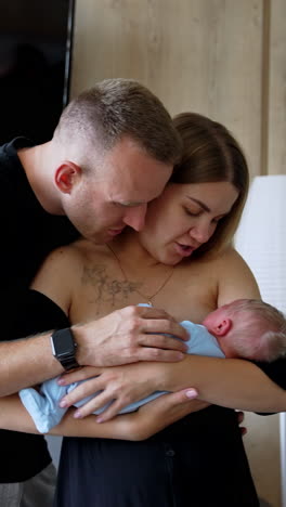infant family parenthood. young parents with newborn baby. vertical video