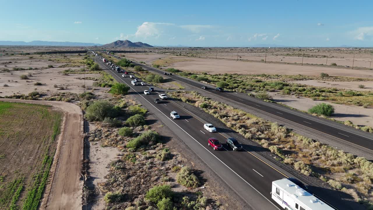 Aerial View of Slow Traffic on Interstate 10 Between Phoenix and Tucson Arizona, People getting off work early evening and heading home, highway in desert, blue skies few clouds, Late September