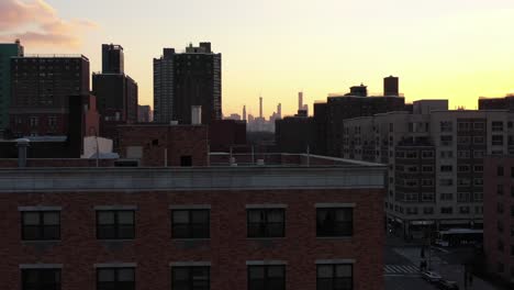 epic drone rise over new york city's harlem neighborhood at gorgeous sunset golden hour