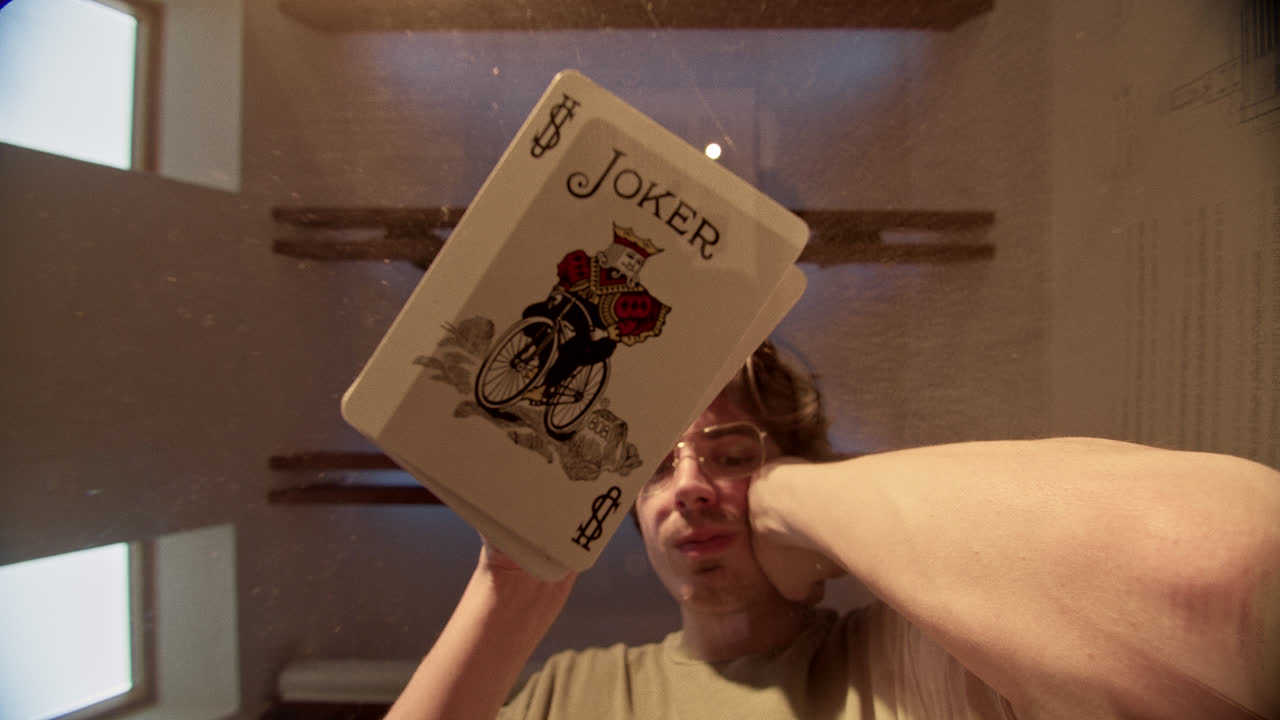 Close-up of a Joker Playing Card Held by a Person