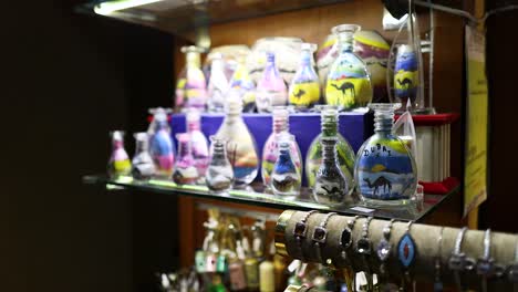 colorful sand art bottles and jewelry display