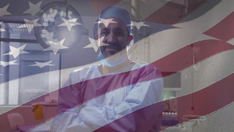 animation of american flag over caucasian male doctor smiling