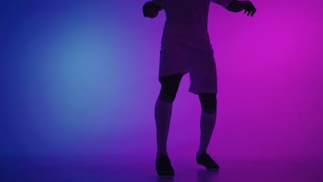 Black-african-man-Freestyle-or-professional-soccer-player-practicing-with-football-ball-juggling-on-legs-slow-motion.-Studio-shooting-of-a-professional-football-player-with-a-ball