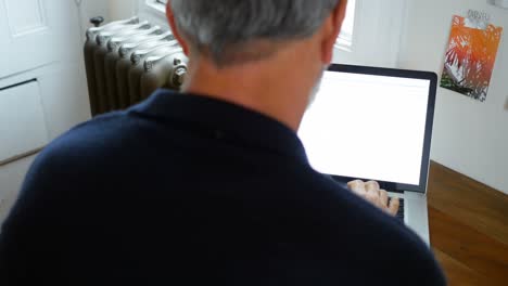 hombre usando portátil en casa 4k