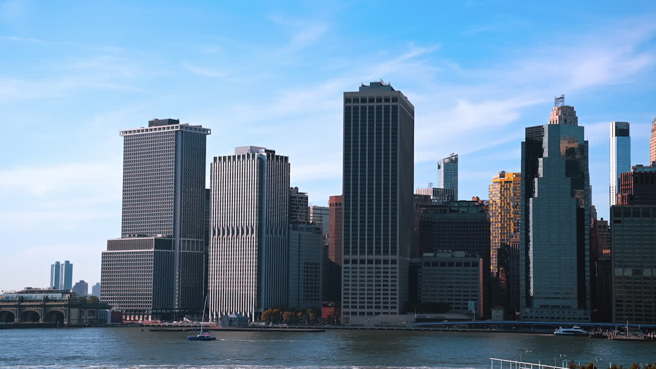 Manhattan high-rises towering above the East River. Architecture of New York from the riverscape