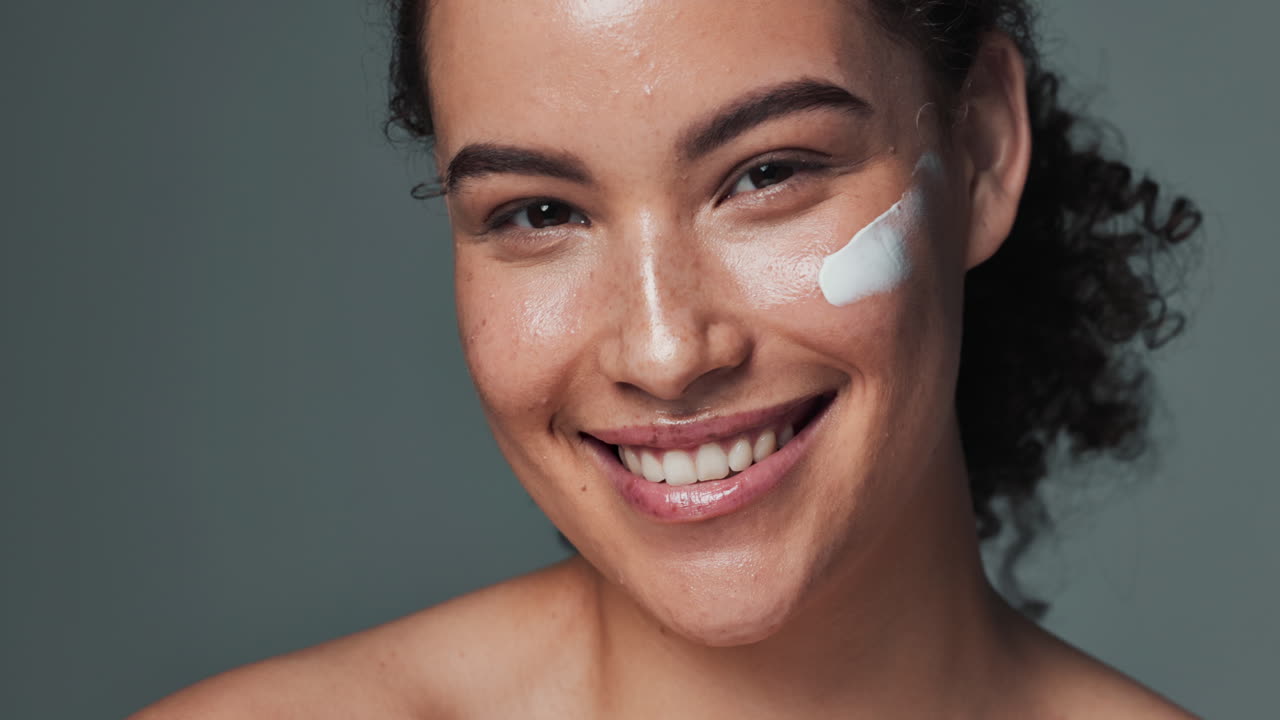 Smiling woman with cream on her face