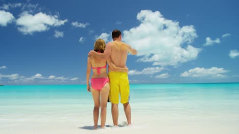 caucasian couple in swimwear on luxury beach vacation