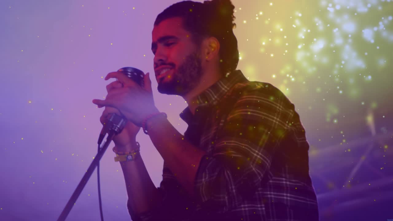 Male singer starting opening line, gripping mic, sparking particle flare and building music climax