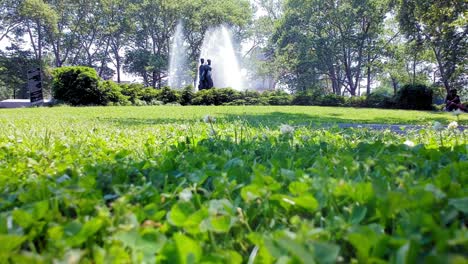 grand army plaza bailey fountain in background of lush green grass in prospect park slope, brooklyn