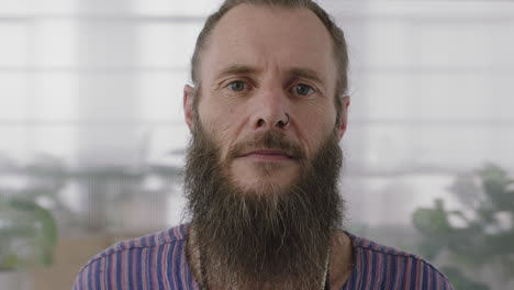 close up portrait of mature hippie entrepreneur man looking serious at camera confident start up businessman with funky beard