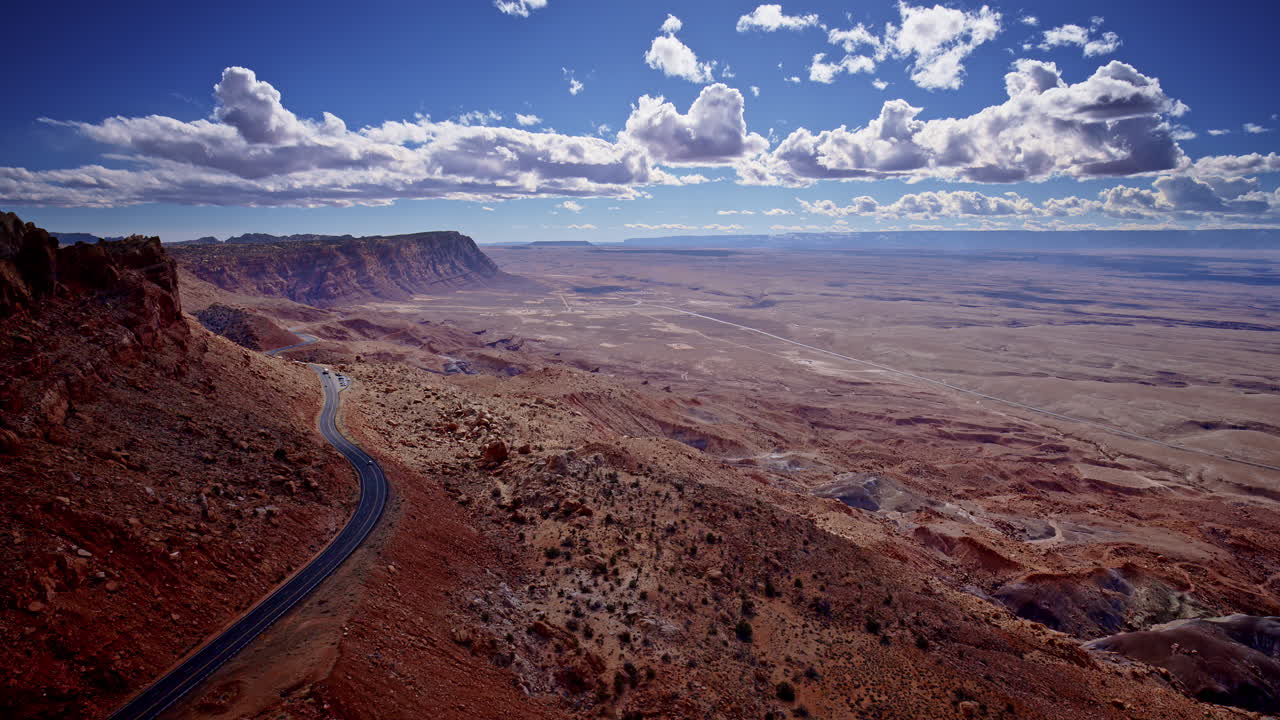 Looking down, a drone captures the chaotic curves of a mountain pass through Arizona’s crimson rocks.
