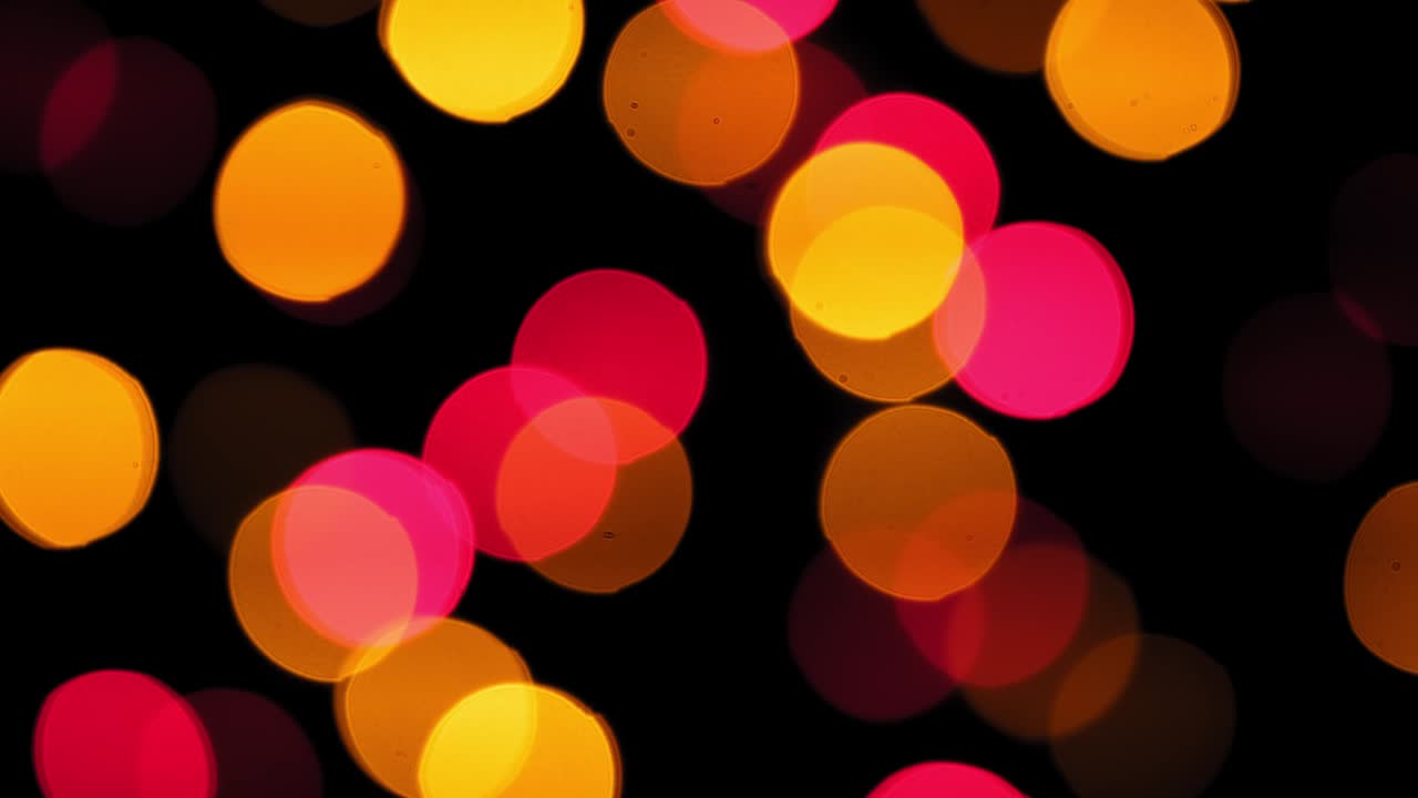 4k. Christmas mood, round defocused multicolored lights. Beautiful New Year screensaver. Merry christmas congratulation. Abstract background of glowing garlands at night. Christmas Garland