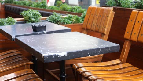 empty table and chairs at an outdoor cafe