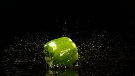 Bell-pepper-falling-on-water-against-black-background-4k