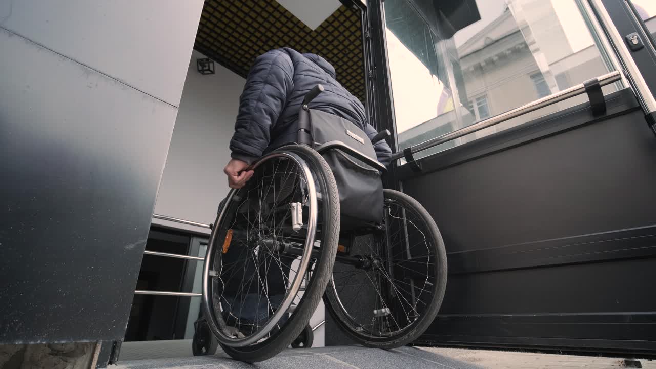 Special elevator for the person with a physical disabilities. A man in a wheelchair uses a special elevator