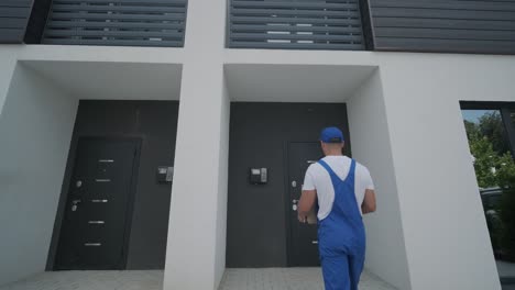 young courier holding a parcel and tablet walking on the street to deliver a box directly to a customer home.