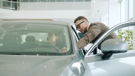 customer and salesperson in car showroom