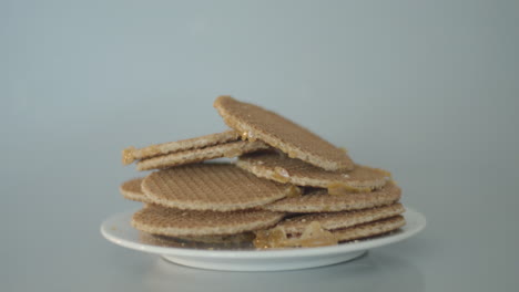 wide dolly of pile of stroopwafels on white plate