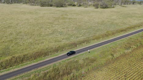 a car travels slowly on a rural road