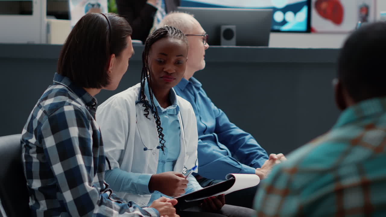 Doctor consulting with patients in hospital waiting room